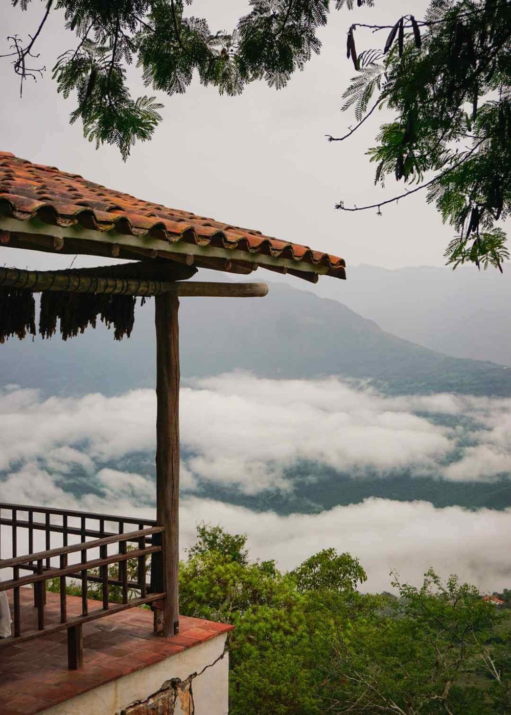 Terraza mirador con techo de teja en Barichara sobre un mar de nubes que cubre el valle al amanecer